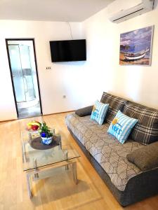 a living room with a couch and a table at Apartment Ante K A1 in Metajna