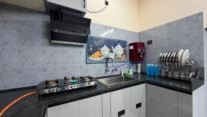 a kitchen with a sink and a counter top at Sky Haven Resort - Private Pool Villa near ECR in Kottaikadu