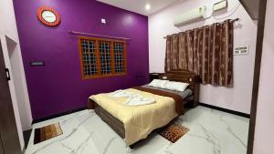 a bedroom with two beds and a purple wall at Sky Haven Resort - Private Pool Villa near ECR in Kottaikadu +140 photos