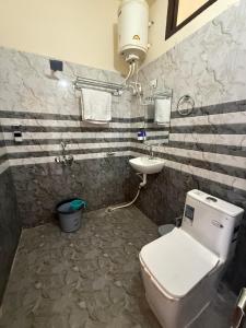 a bathroom with a toilet and a sink at Corn Village Retreat in Mussoorie +28 photos
