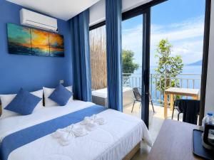 a bedroom with a bed and a view of the ocean at The Cliff Bungalow in Koh Rong Sanloem