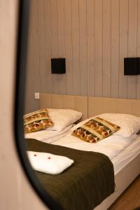 two beds in a room with a mirror at Zacisze Beskidu - Private House with Sauna, Jacuzzi & Pool in Łącko