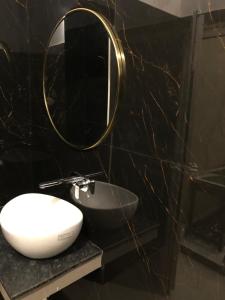 a bathroom with a sink and a mirror on a counter at HOTEL BREEZE NEW JALPAIGURI in Siliguri