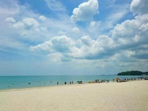 a group of people on a beach with the ocean at Coastline Hotel 6 Avenue PortDickson in Port Dickson