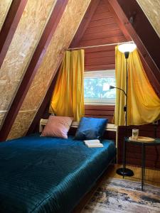 a bedroom with a bed and a window in a attic at Ostoja Lipiny in Sompolno +82 photos