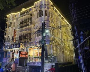 a building with christmas lights on the side of it at HOTEL BREEZE NEW JALPAIGURI in Siliguri +18 photos
