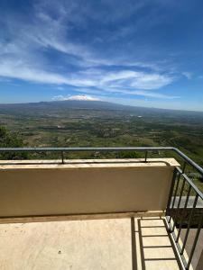 a view of a snow covered mountain from a balcony at Kento Resort Hotel in Centuripe