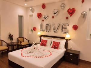 a bedroom with a bed with hearts and balloons at Chau Pho Hotel in Chau Doc