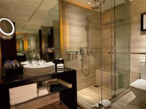 a bathroom with a shower and a sink and a toilet at Courtyard By Marriott Shanghai Xujiahui in Shanghai