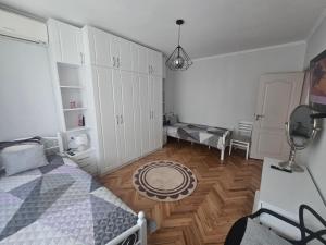 a bedroom with a bed and a wooden floor at Sweet Home in Burgas