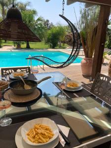 a table with plates of food and a bowl of french fries at The Bamboo villa in Casale la Cogna +22 photos