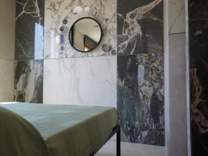 a room with a mirror on a wall at RESIDENCE SOLARIDE apartments, FREE PRIVATE PARKING WITH VIDEOSURVELLIANCE and SHUTTLE SERVICE in Salerno