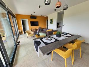 a living room with a table and a couch at Vila Dora with Private Pool in Radetići