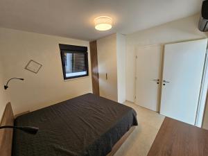 a bedroom with a bed and a window and a door at Vila Dora with Private Pool in Radetići