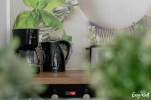 a black coffee maker sitting on a wooden shelf at Piastowska in Pobierowo