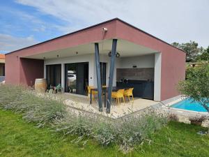 a house with a patio and a swimming pool at Vila Dora with Private Pool in Radetići
