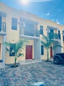 a house with a car parked in front of it at Revo Apartments in Lusaka