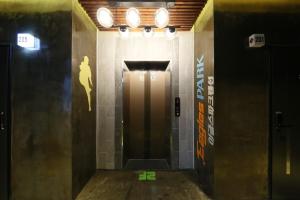 a hallway with a door with a woman on the wall at Boryoung Eagle Spark Pension in Boryeong