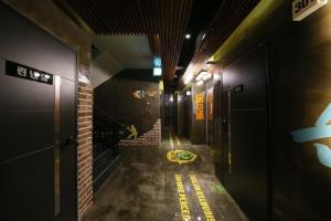 a hallway of a building with a yellow line on the floor at Boryoung Eagle Spark Pension in Boryeong +6 photos