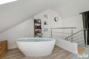 a white bath tub in a room with stairs at Piastowska in Pobierowo +69 photos