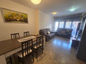 a living room with a table and a couch at APARTAMENTO CONSTITUCIÓN in Benicarló