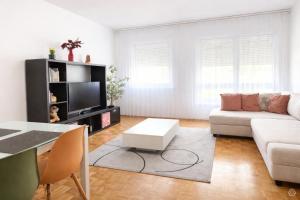 a living room with a couch and a table at Appartement Coeur de Ville in Lausanne