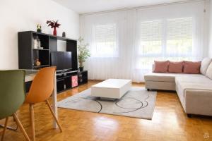 a living room with a couch and a table at Appartement Coeur de Ville in Lausanne +19 photos