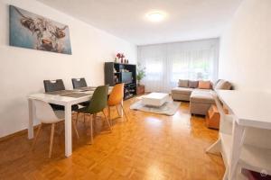 a living room with a table and chairs and a couch at Appartement Coeur de Ville in Lausanne