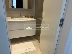 a bathroom with a sink and a mirror at Green Coast 244d - by Ale Investa in Palasë +15 photos