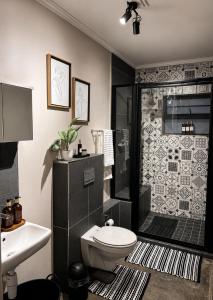 a bathroom with a shower and a toilet and a sink at Garden View Suite in Gqeberha