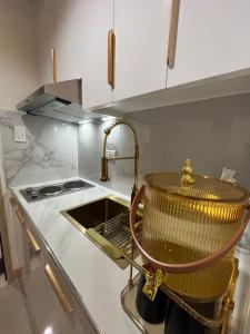a kitchen with a sink and a basket on the counter at Jade Mantle Sanctuary in Manila +4 photos