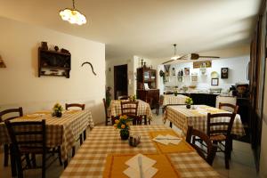 a dining room with two tables and a kitchen at TERRA MIA in Città Giardino