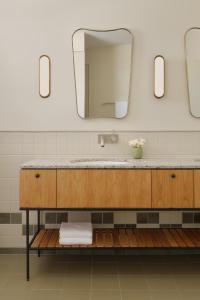 a bathroom with a sink and a mirror at Owston Hotel in Fremantle