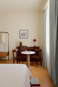 a room with a bed and a table and chairs at Owston Hotel in Fremantle +16 photos