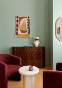a living room with two chairs and a table at Owston Hotel in Fremantle