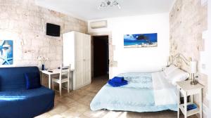 a bedroom with a bed and a table and a desk at Ape Rossa in Castellana Grotte