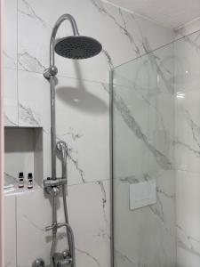 a shower with a glass door in a bathroom at Kambi rooms in Himare