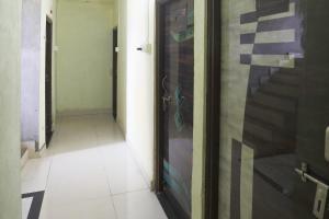 a hallway with a glass door with at Hotel O Celebrity in Chandrapur