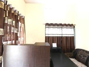 a podium in a room with a curtain and a window at Hotel O Celebrity in Chandrapur