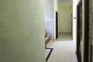 an empty hallway with a stairway in a building at Hotel O Celebrity in Chandrapur