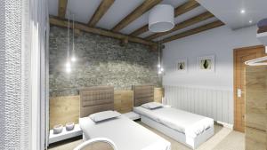 two beds in a room with a brick wall at Pansion Vila Vrsar in Vrsar