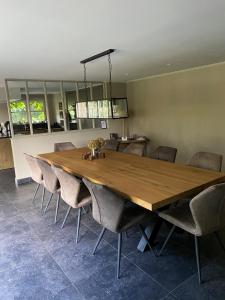 a large wooden table and chairs in a room at Maison l'amitié in Ellezelles +23 photos