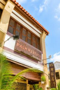 a sign on the side of a building at Palm Mansion Boutique Suites in George Town