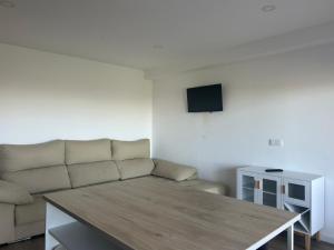 a living room with a couch and a table at Quinta da Mainça in Coimbra