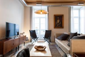 uma sala de estar com um sofá e uma televisão em ALTIDO Downtown Design Apartments em Lisboa