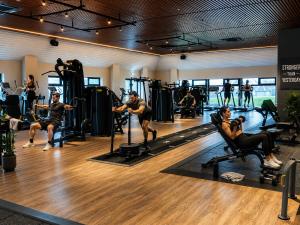 a group of people exercising in a gym at The Wiltshire Hotel, Golf and Leisure Resort in Swindon