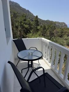 a table and chairs on a balcony with a view at Nikos Apartments in Lefkos Karpathou +22 photos
