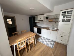 a kitchen with a wooden table and a table and chairs at Nevoliani stone house in Florina