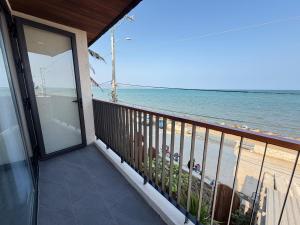 a balcony of a house with a view of the ocean at Phuongvilla Đông Hải in Thôn Ðông Giang