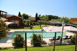 a resort with a swimming pool with umbrellas at Hotel Ristorante la Luna in Sarzana +46 photos
